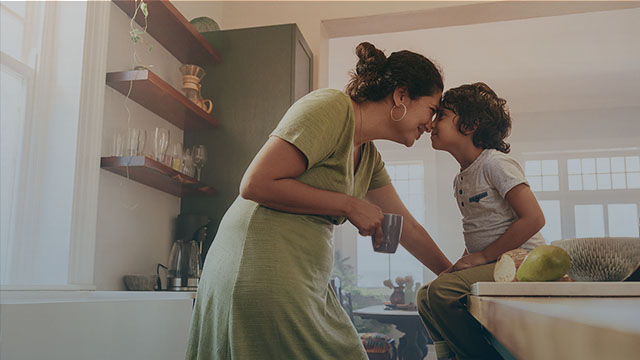 A mother and child share a sweet moment in their kitchen.