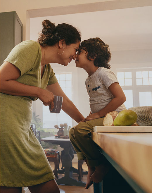 A mother and child share a sweet moment in their kitchen.