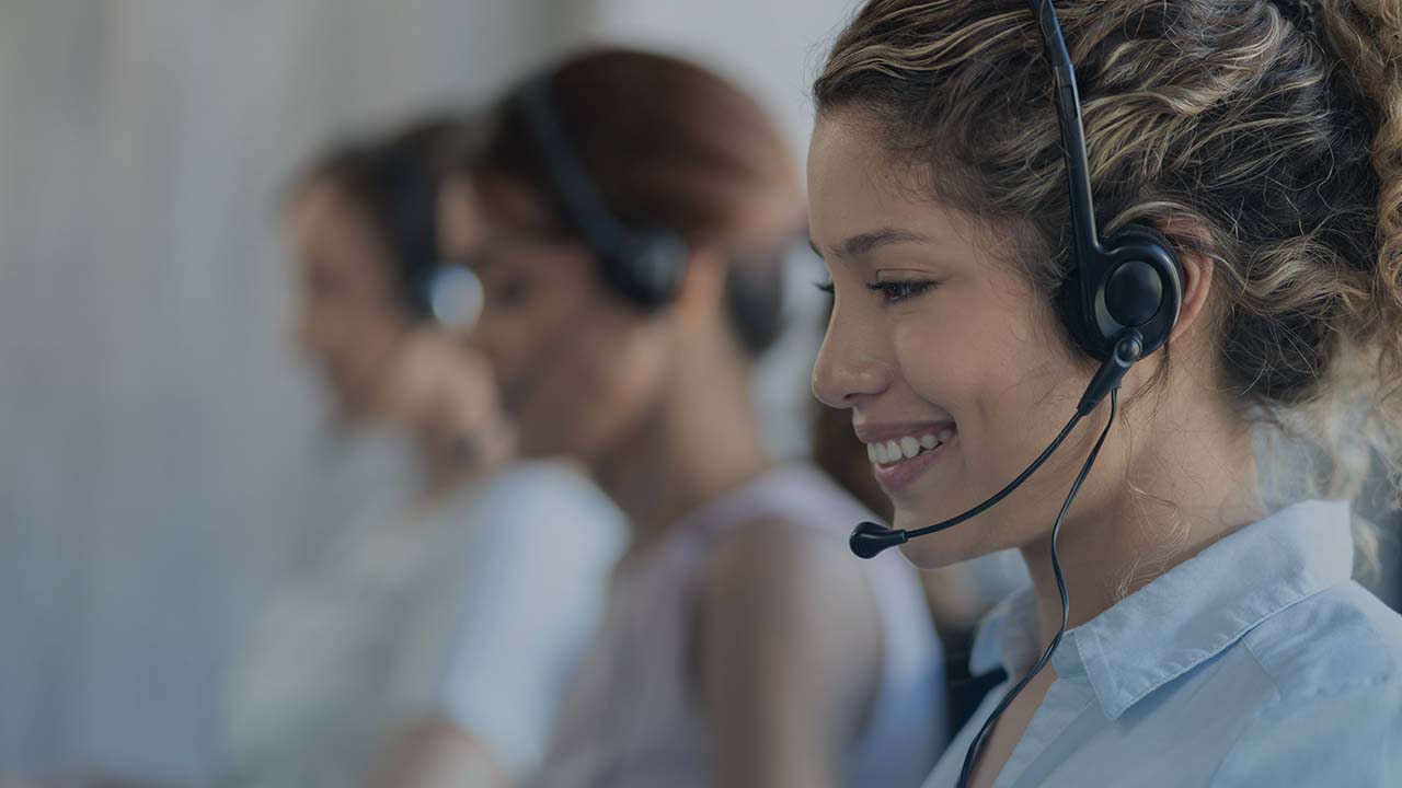 Young woman wearing a call headset and smiling. Young woman wearing a call headset and smiling.